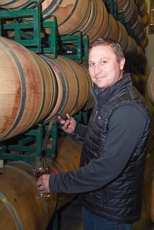 Jason Robideaux with barrels on the lees
