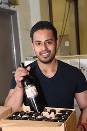 Ulises Barron handling bottles in a box